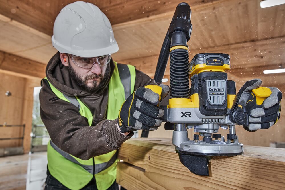 Construction worker using the 12mm plunge router edge attachment on timber