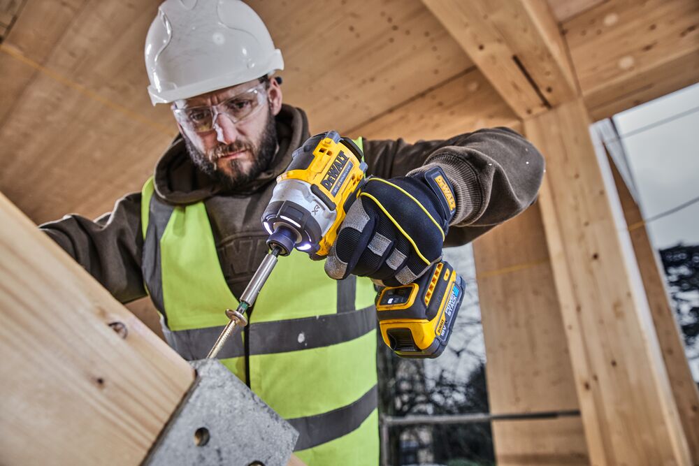 Construction worker uses 18V XR 4 Speed Premium Impact Driver to drive a bolt