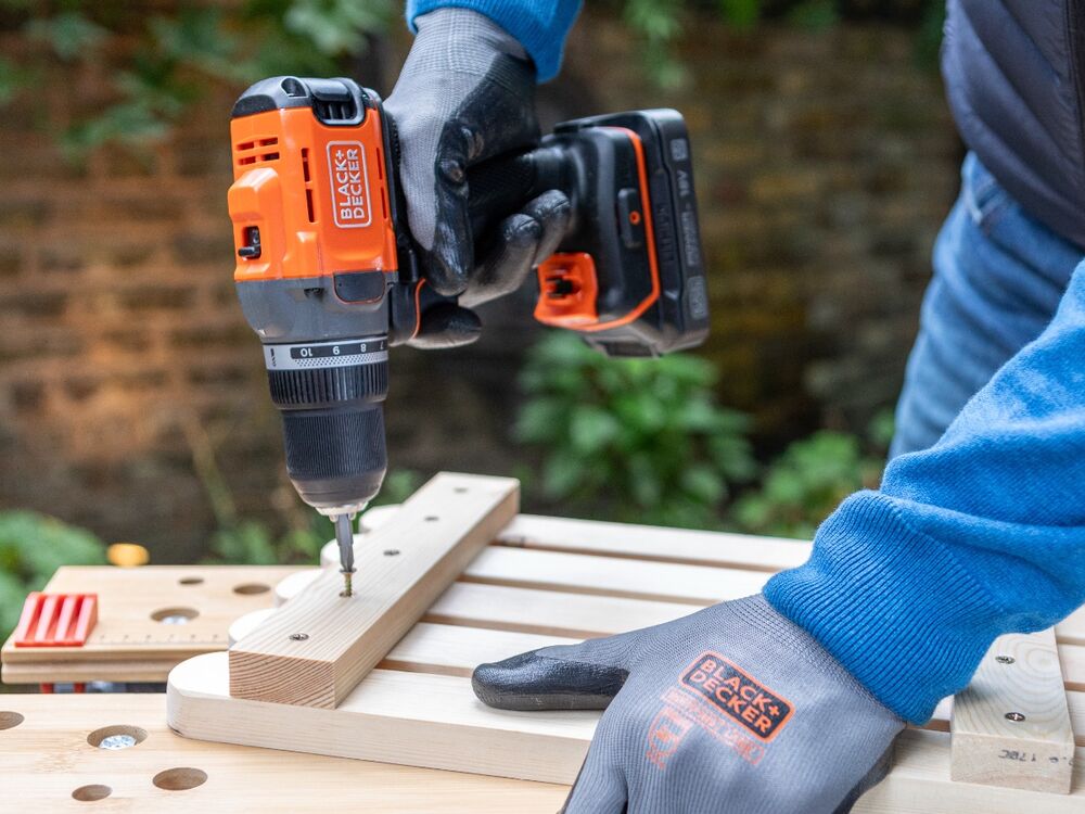 Backing wood being screwed to slats using the BLACK+DECKER POWERCONNECT 18V Cordless Drill Driver.