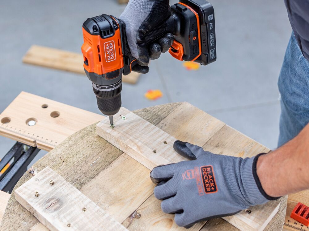 A wooden pumpkin project being screwed together using the BLACK+DECKER POWERCONNECT 18V Cordless Drill Driver.