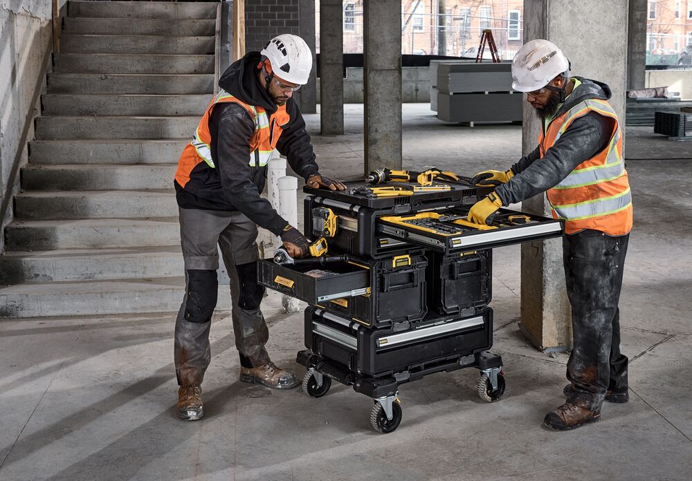 Two workers using the 5in1 tower, sorting out tools within the deep and shallow drawers - DWST08530-1, DWST08550-1, DWST08520-1, DWST08510-1