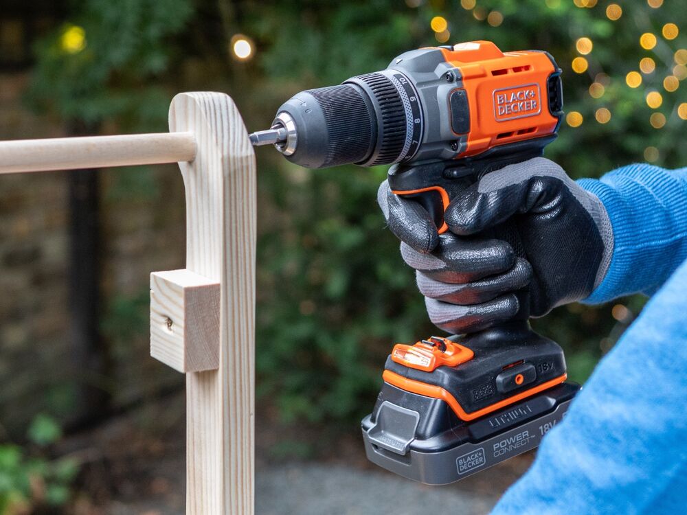 A wooden mini sleigh frame being assembled using the BLACK+DECKER POWERCONNECT 18V Cordless Drill Driver.