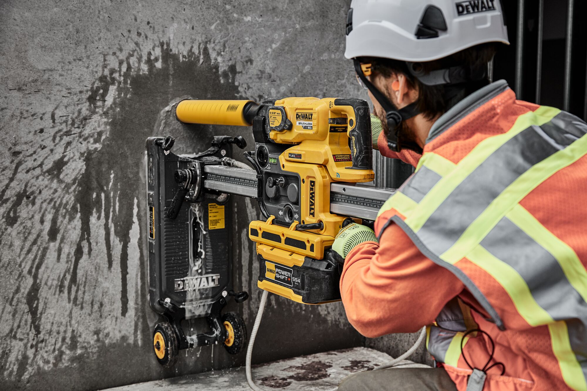 Man drilling hole in wall with core drill