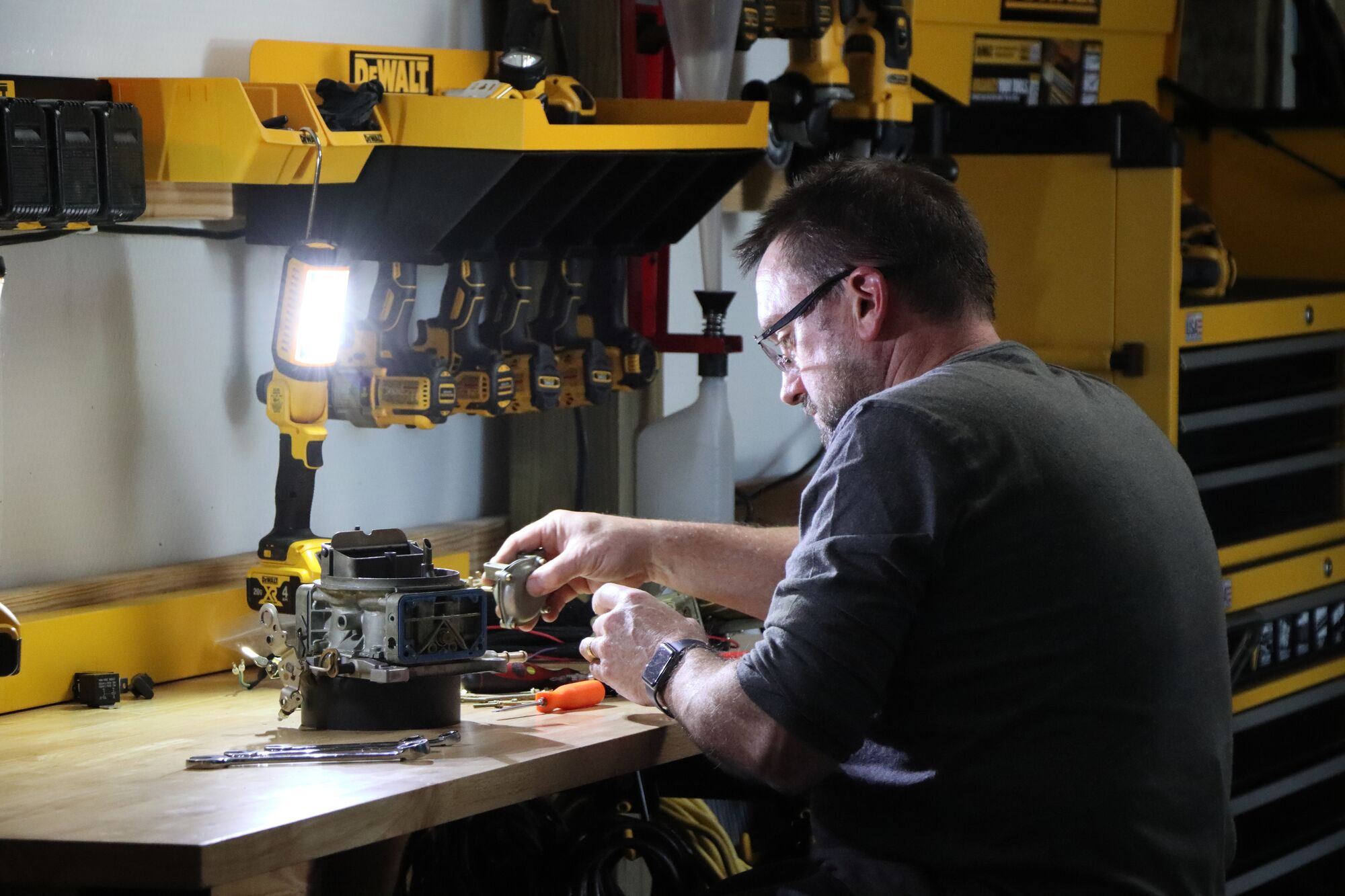 Chris Gilligan, aka Spider, works at his workbench surrounded by DEWALT tools and storage solutions