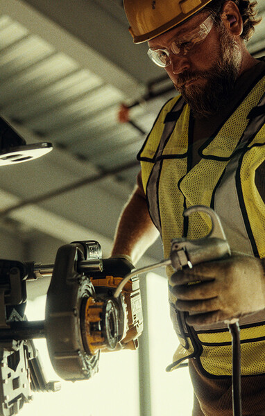 A tradesperson uses a DEWALT threaded rod cutter