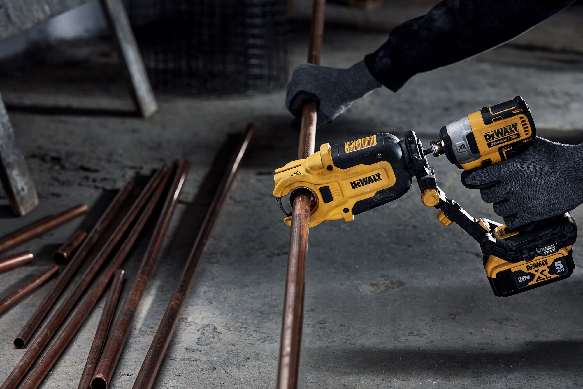 End user using DEWALT IMPACT CONNECT Copper Cutter attachment on Impact Driver to cut copper pipe.