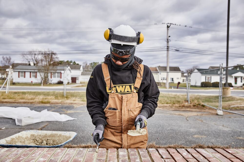 A member of Rodney's crew works on laying bricks at the jobsite