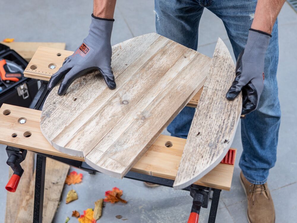 The wooden pieces of a pumpkin project being assembled.