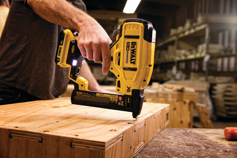 XR 18 GA Cordless Narrow Crown Stapler in action on a wooden board at a construction site