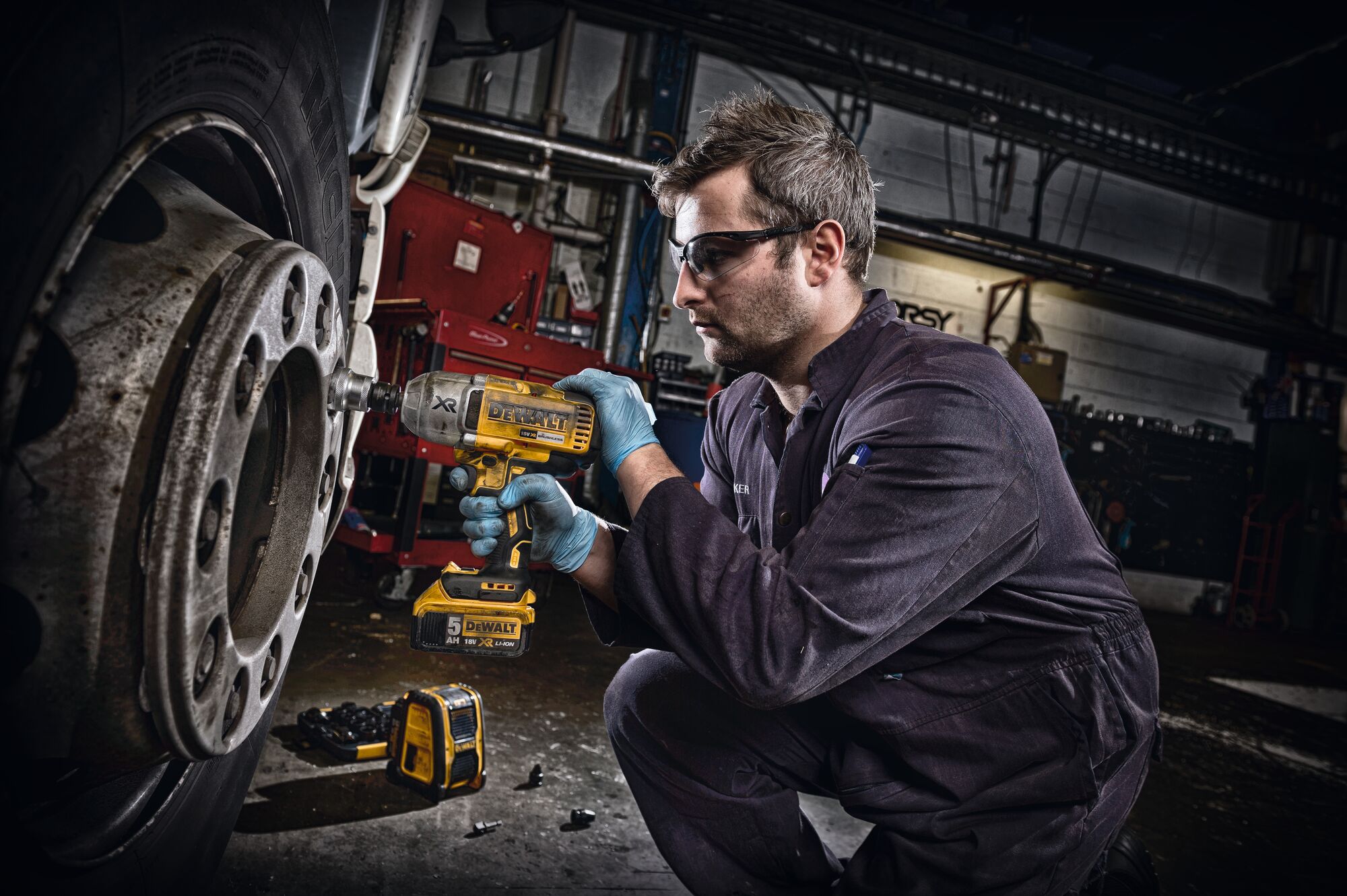 WRENCH W. DETENT PIN ANVIL being used on a tire by a person