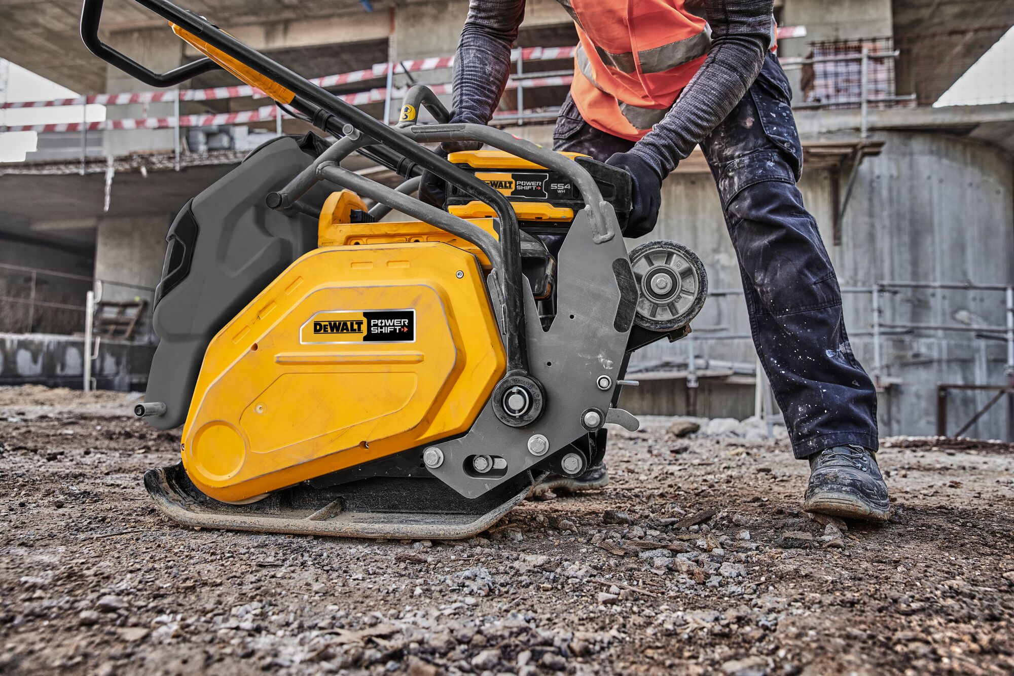 Man taking out battery on plate compactor