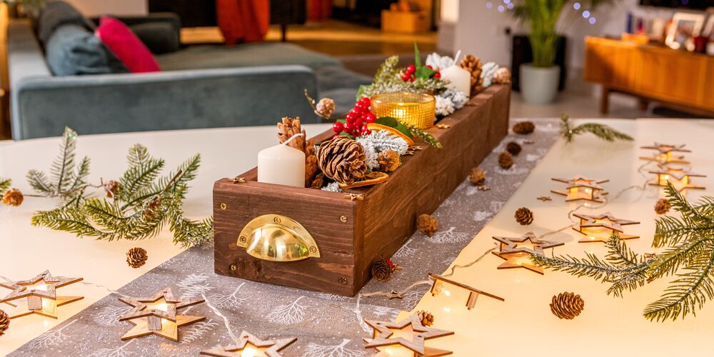 A festive wooden candle holder on a living room table.