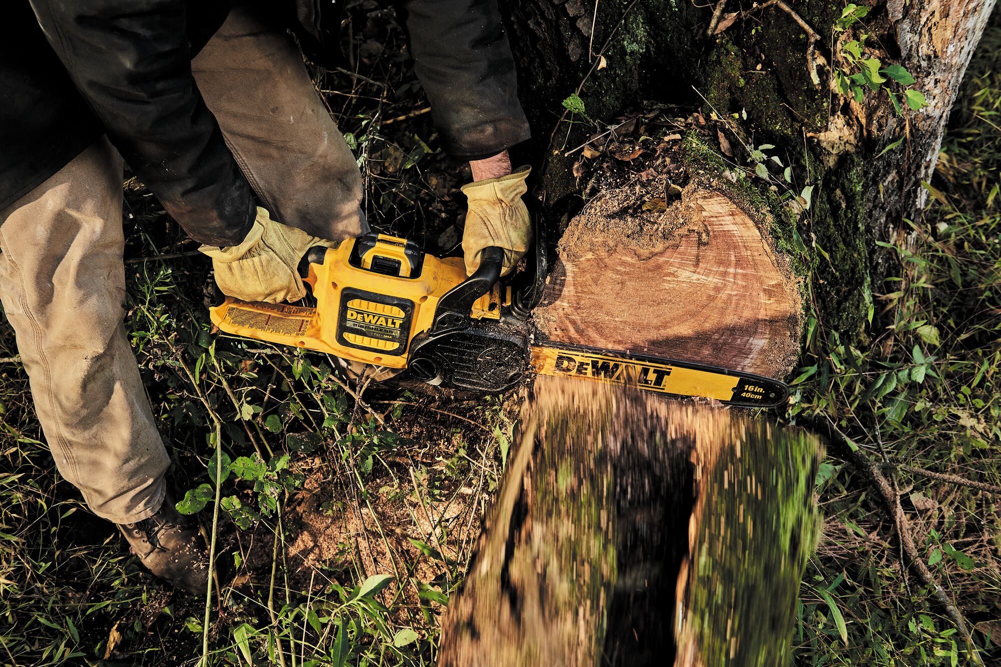 FLEXVOLT Cordless Chainsaw in use on a large tree trunk outdoors