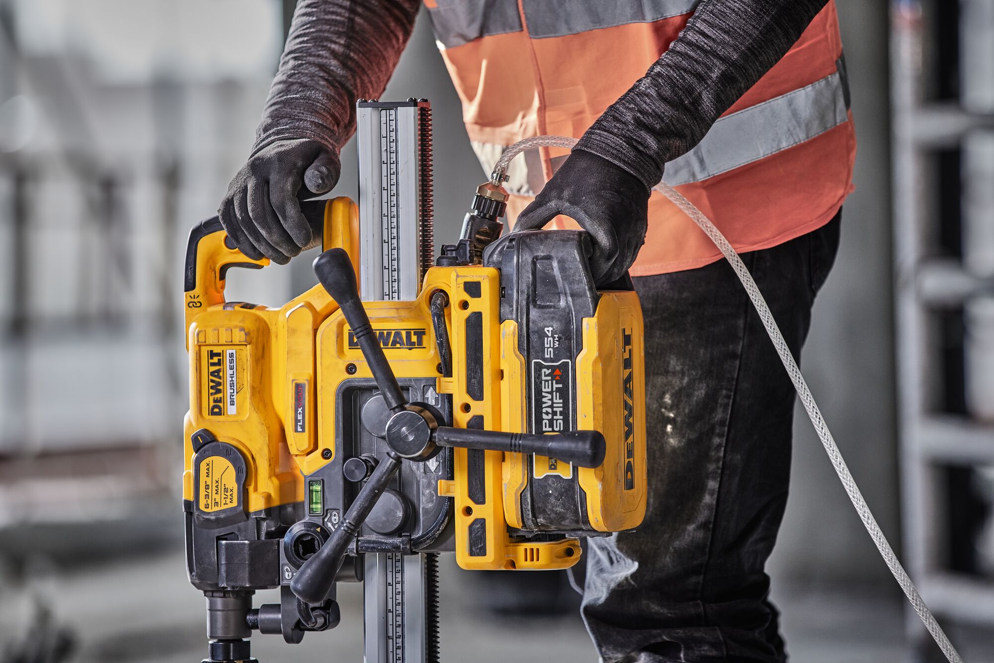 Man inserting battery into core drill stand 