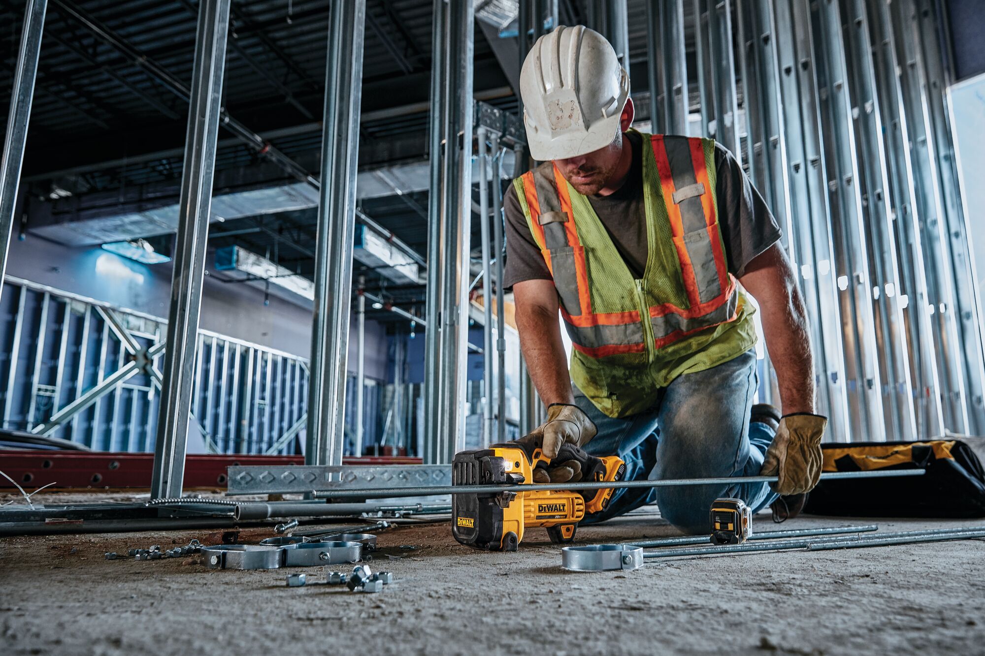 Threaded Rod Cutter being used by worker to cut a threaded steel rod at a construction site