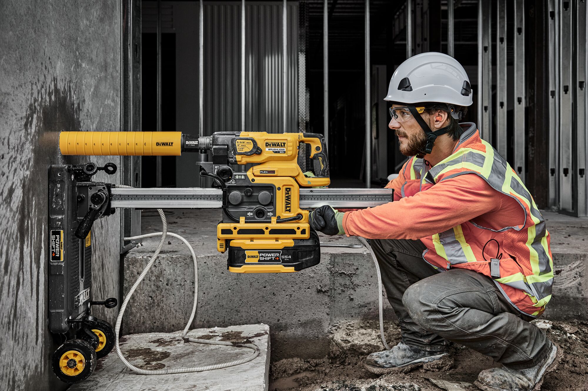 Man drilling hole in wall with core drill