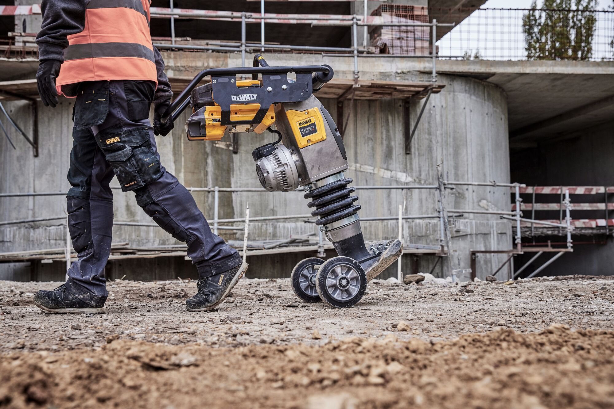 Man pulling rammer using wheels